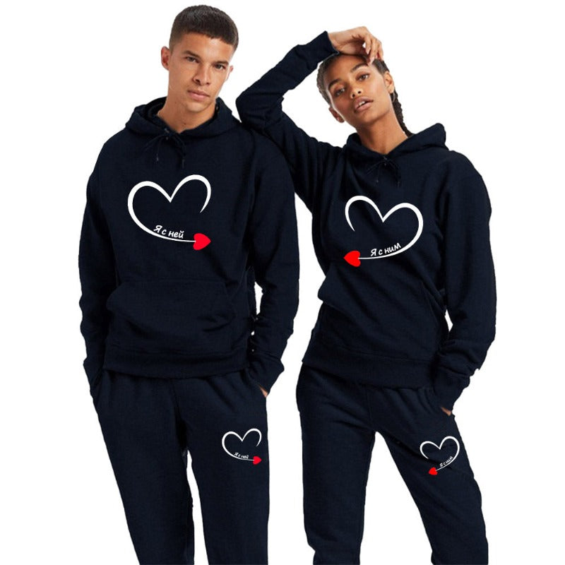 Matching men's and women's black couple hoodies with romantic heart print