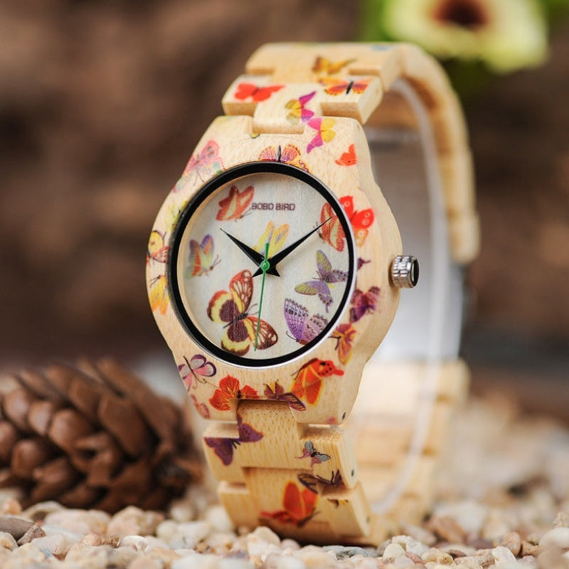 Wooden watch with butterfly design on a natural background