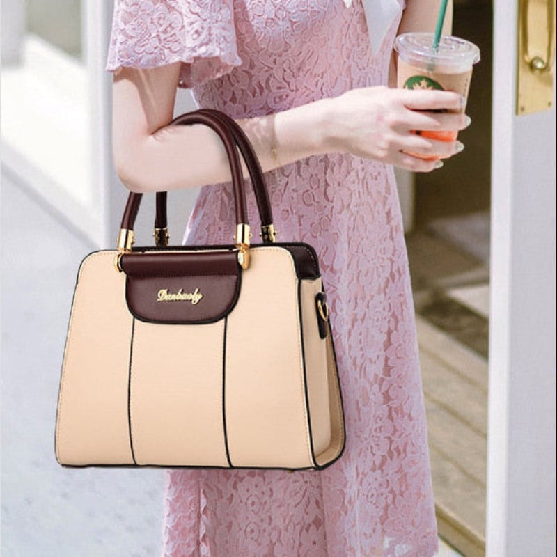 Woman holding a beige handbag with a matching crossbody bag displayed below.