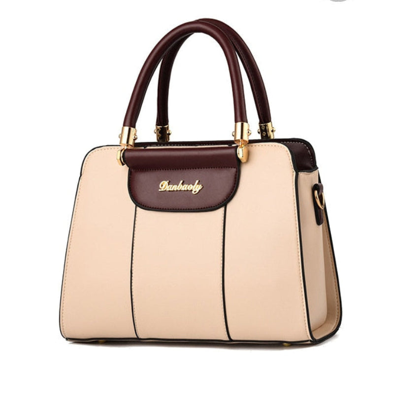 A structured handbag shown from multiple angles on a white background, with a top-down view at the top, a front view in the middle, and a side view at the bottom. The bag has a cream-colored body with dark brown trim, double top handles, and gold-tone hardware.