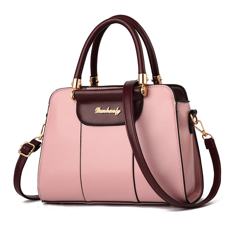 A structured handbag in light pink and dark burgundy faux leather with gold-tone hardware, featuring dual top handles, a front flap pocket with the brand name 'Bunhuawei' in gold script, and a detachable shoulder strap, shown on a white background.