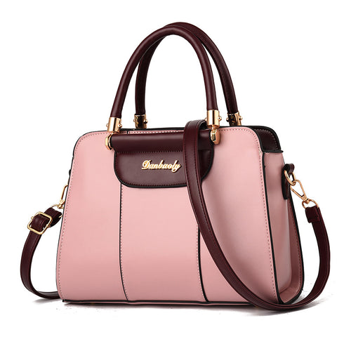 A structured handbag in light pink and dark burgundy faux leather with gold-tone hardware, featuring dual top handles, a front flap pocket with the brand name 'Bunhuawei' in gold script, and a detachable shoulder strap, shown on a white background.