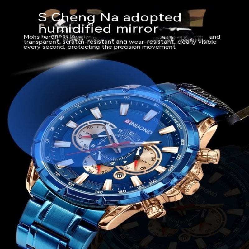 A men's sport watch with a blue metallic case and strap, gold-tone side pushers and crown, and a blue dial with multiple subdials. The watch is shown on a dark background with promotional text at the top about a humidified mirror.