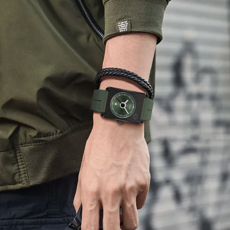 Person wearing a green watch with a matching jacket and bracelet on a blurred background