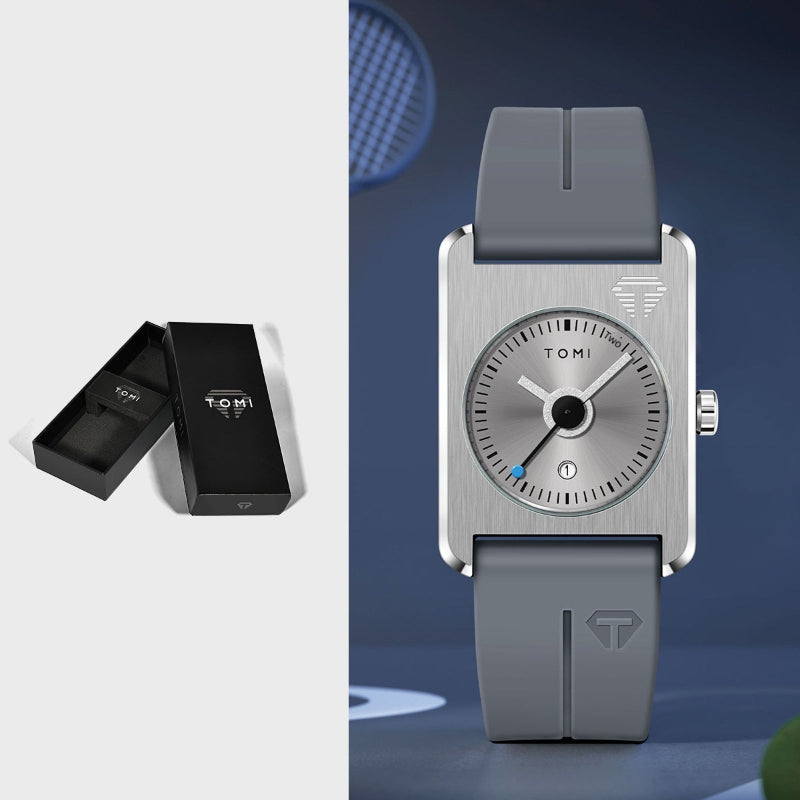 Gray wristwatch with a matching box on a blue background