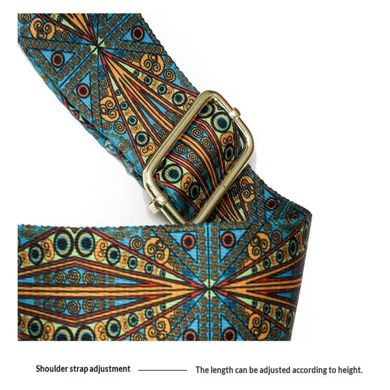 A close-up of a patterned shoulder strap with a brass buckle, showing a blue, orange, and black geometric design. A text label at the bottom reads 'Shoulder strap adjustment' with 'The length can be adjusted according to height.