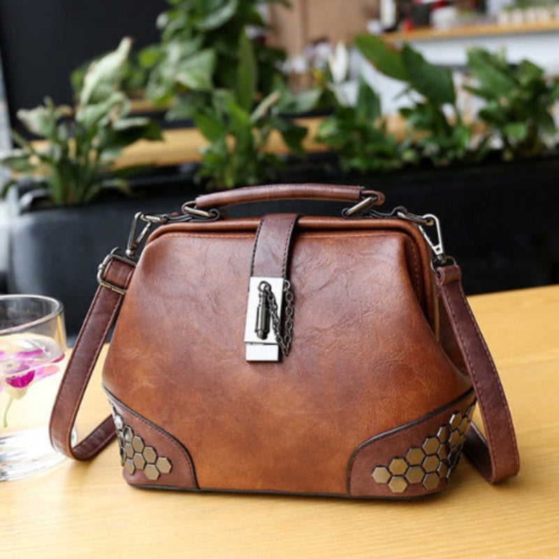 Brown leather handbag with decorative elements