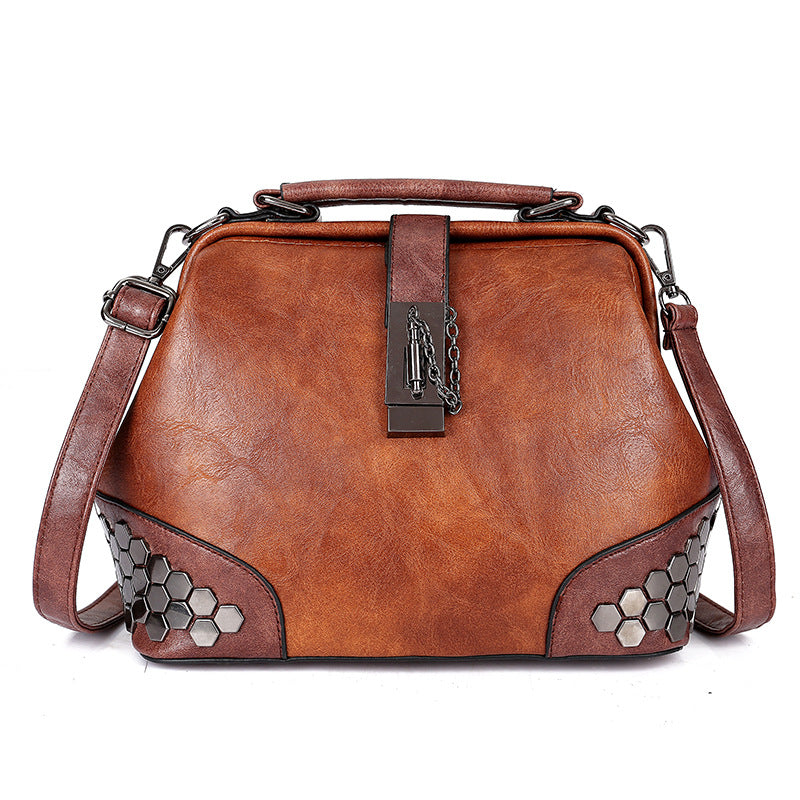 Brown leather handbag with hexagonal pattern on a white background