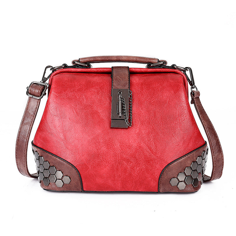 Red handbag with brown accents and hexagonal patterns on a white background