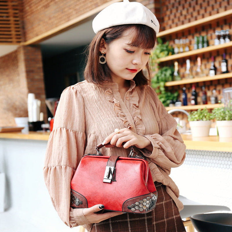 Woman holding a red handbag in an indoor setting