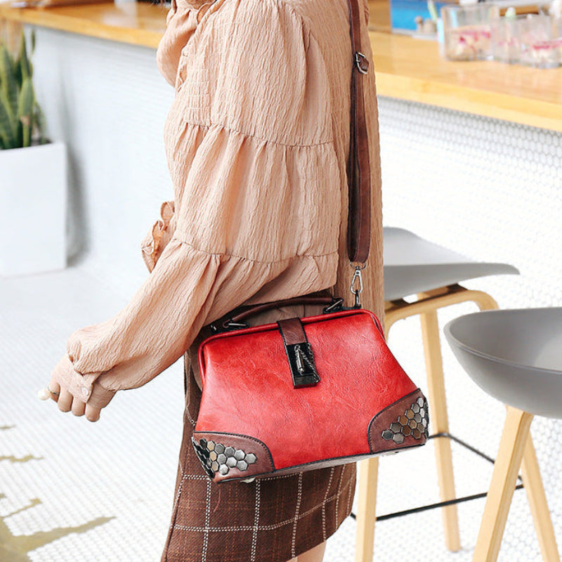 Person holding a red handbag in an indoor setting