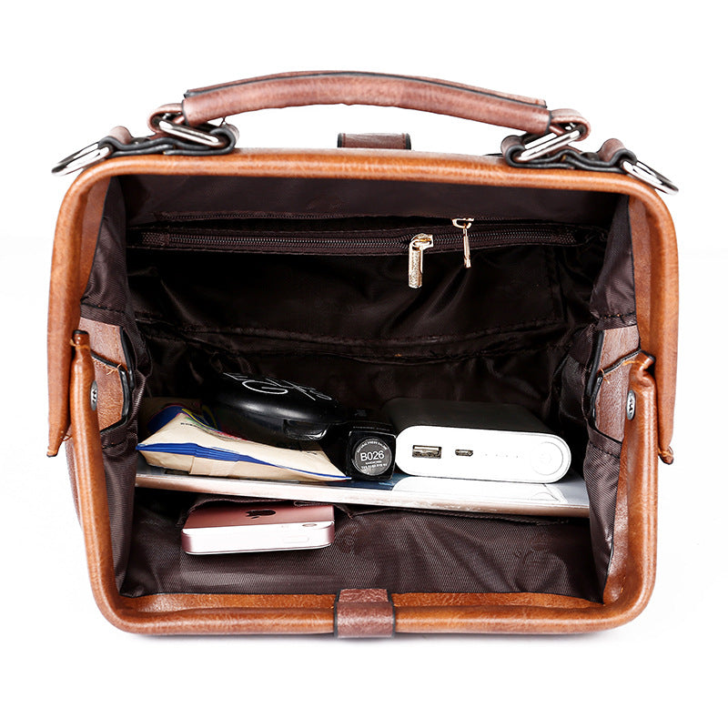 Brown leather briefcase with items inside